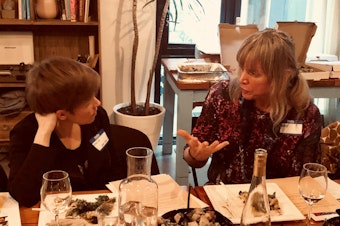 caption: Queeriosity Club members Dacia Clay (left) and Jennifer Hegeman  talk during KUOW's first Pride-themed Curiosity Club dinner at The Cloud Room in Seattle. June 7, 2019. 