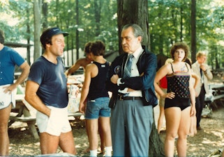 caption: SLIDESHOW: An agent speaks with former president Richard Nixon at one of his picnics. This was after Nixon resigned from the presidency, the only president in history to do so. This photo, and those following, were provided to KUOW by Nixon's Secret Service agent, Mike Endicott. These images were captured by the agents and staff assigned to Nixon's detail after he left office in 1974.