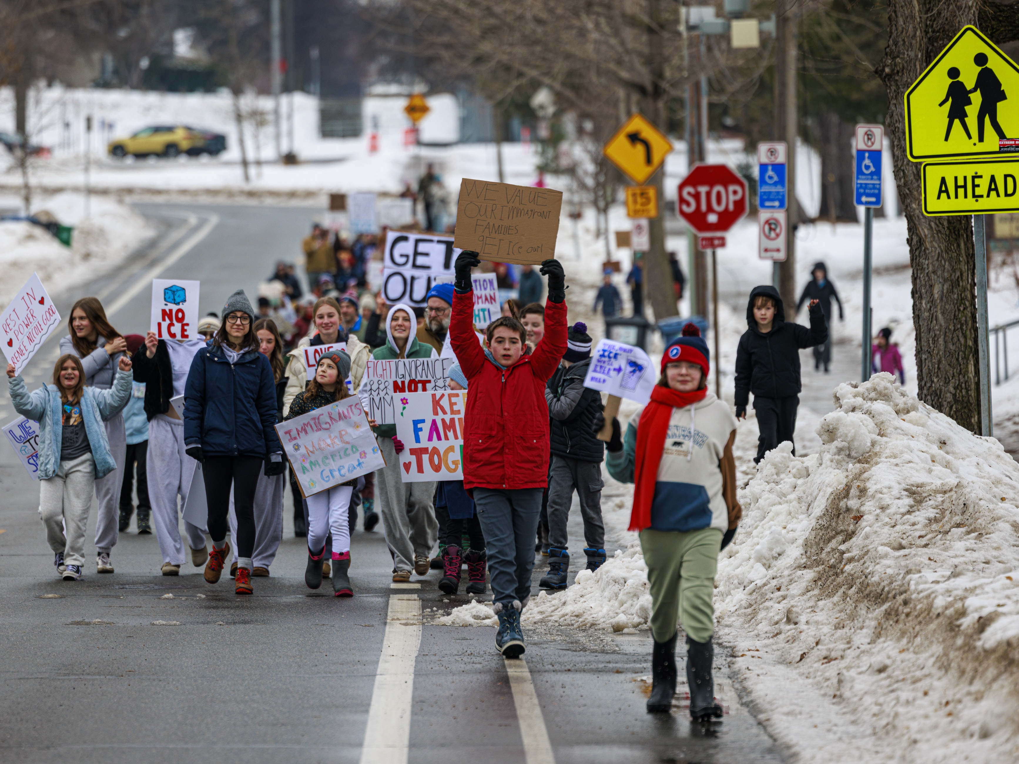 caption: Young students march near Kenny Community School in Minneapolis, on Thursday, Jan. 8, 2026, a day after an ICE agent shot and killed a 37-year-old woman.