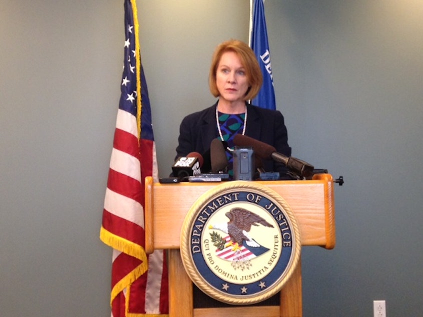 caption: U.S. Attorney Jenny Durkan talks to reporters about police reform at the Federal Building in Seattle in May.