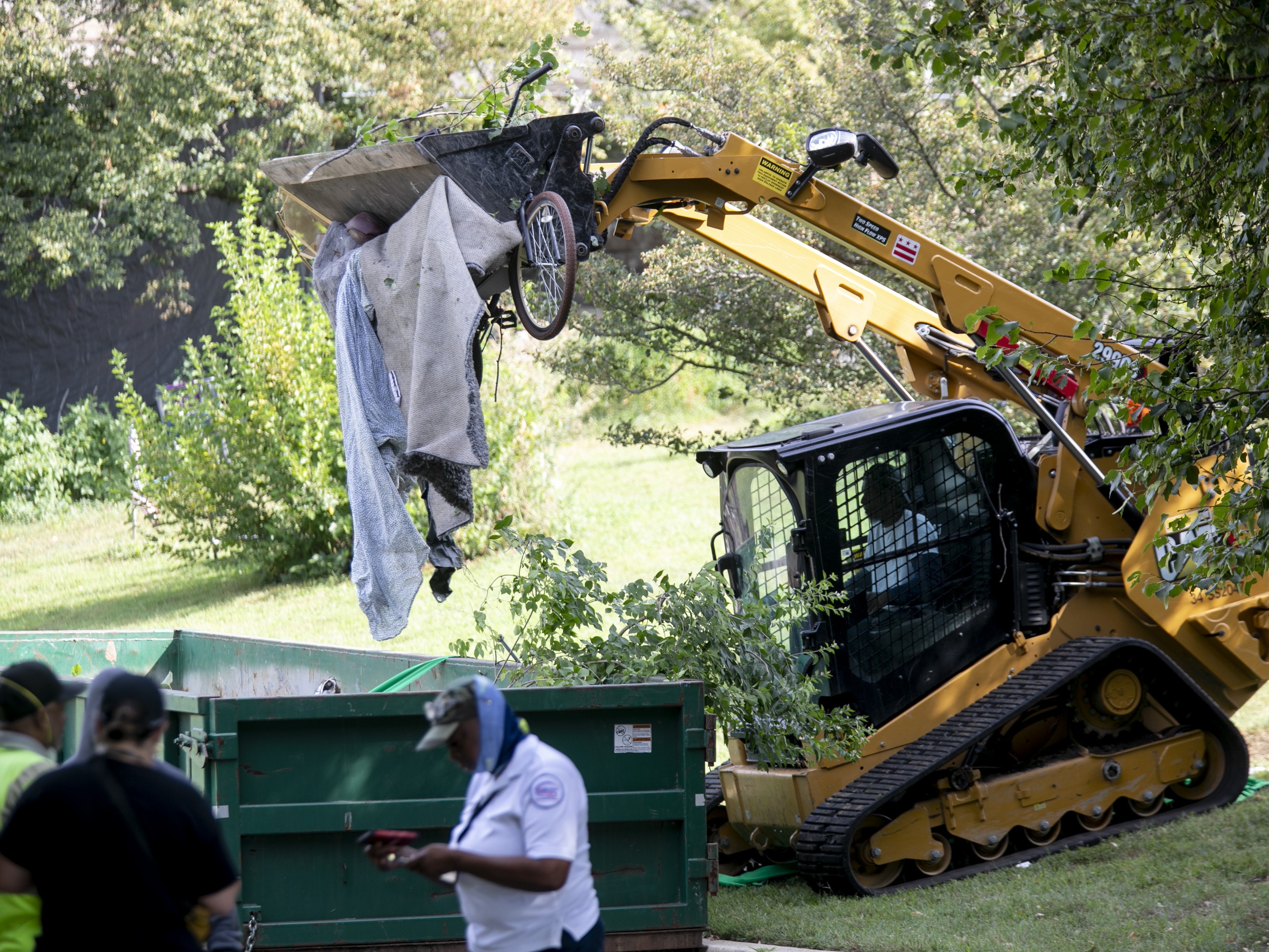 caption: An encampment for the unhoused in Washington D.C. near the Kennedy Center was cleared by employees of the city's Department of Health and Human Services. The residents of the encampment packed up their belongings and left with the help of city outreach workers as well as non-profit employees and volunteers.