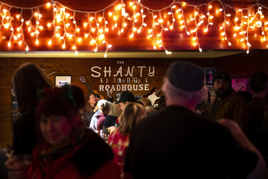 caption: The Shanty Tavern is packed on Friday, December 19, 2025, in Lake City, with a line out the door during the last night of business for what many call the 'last roadhouse in Seattle.'