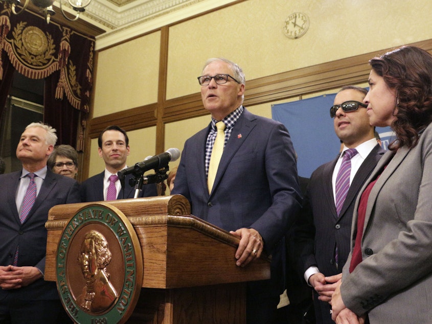 caption: Washington Gov. Jay Inslee recently signed legislation making Washington the first state to enter the private health insurance market with a universally available public option.