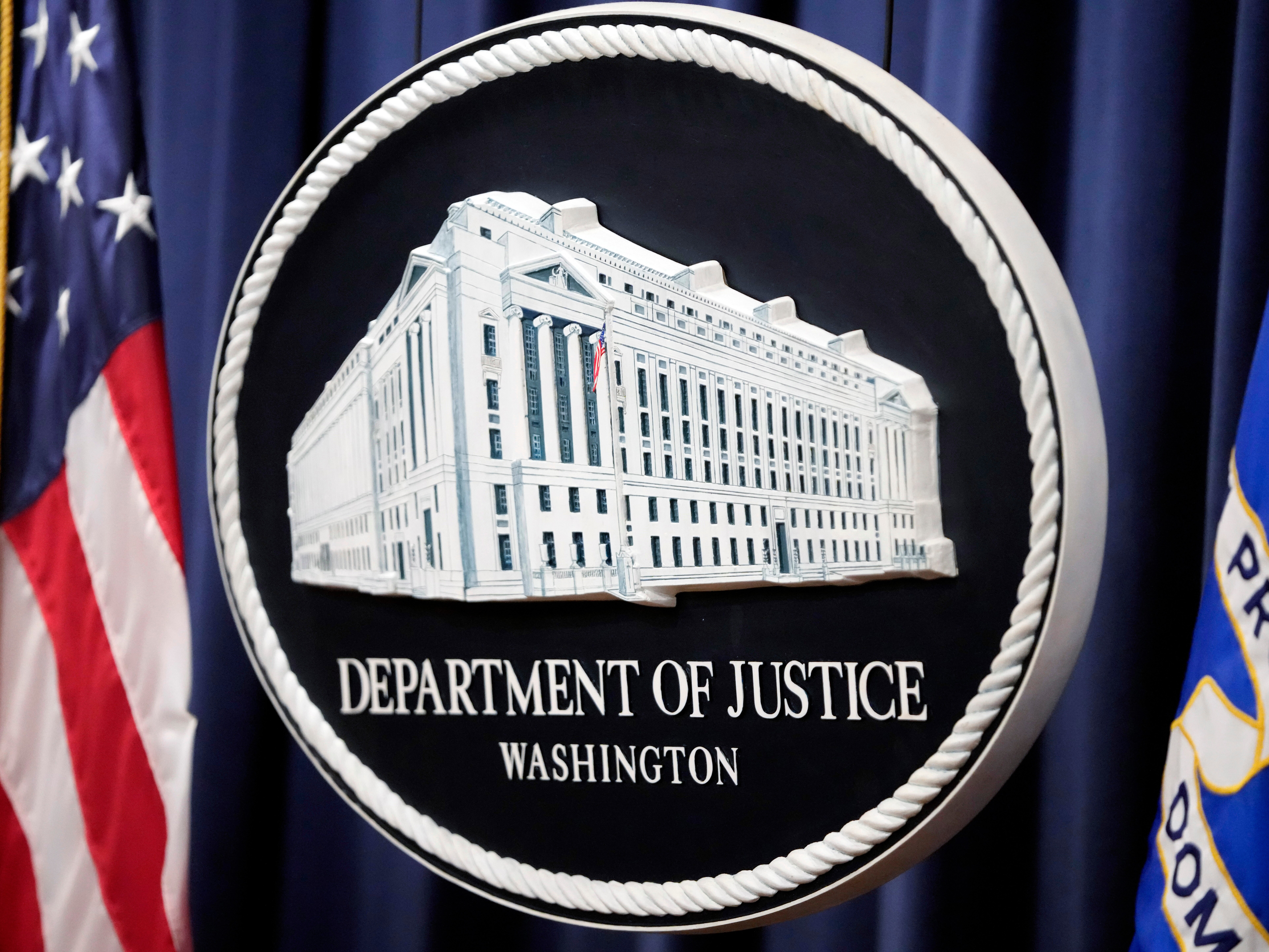 caption: The logo for the Justice Department is seen before a news conference at the Department of Justice on Aug. 23, 2024, in Washington.