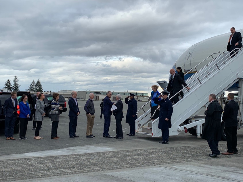 caption: Wash. Gov. Jay Inslee greets the arrival of Vice President Mike Pence in Washington state with an elbow bump