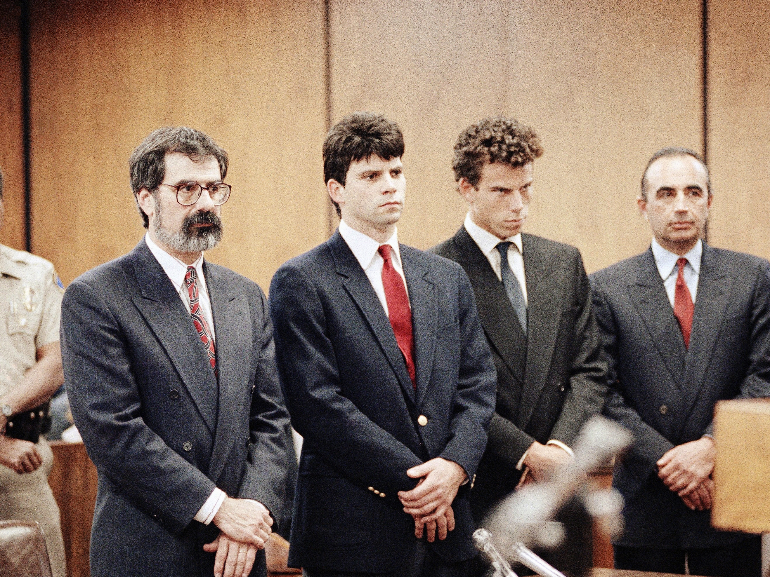 caption: Lyle Menendez (second from left) and his brother, Erik are flanked by their attorneys Gerald Chaleff (left) and Robert Shapiro, in Beverly Hills Municipal Court in 1990.