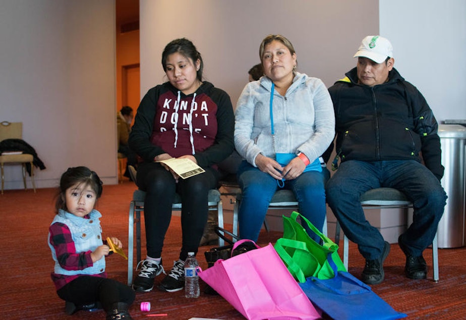 caption: A family waits to speak with an immigration attorney at a free legal clinic hosted by the City of Seattle