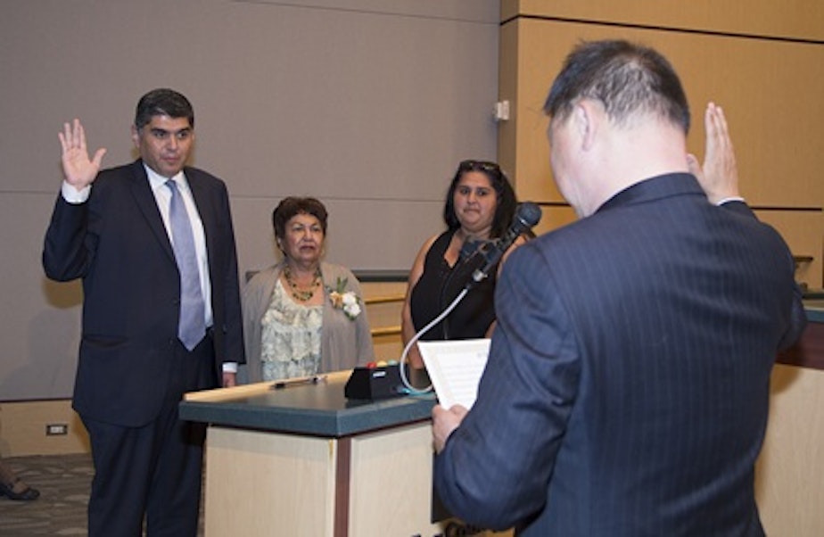 caption: State Rep. Javier Valdez is sworn in by Judge Dean Lum