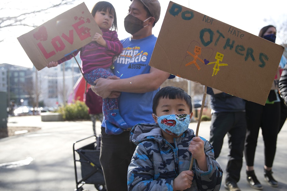 caption: Grayson Chan, 5, holds a sign that reads 'Do Not Hate Others,' while standing with his family during the 'We Are Not Silent' rally and march against anti-Asian hate and violence on Saturday, March 13, 2021, at Hing Hay Park in Seattle. Several days of actions are planned by rally organizers in the Seattle area following recent attacks and violence against Asian American and Pacific Islander communities.