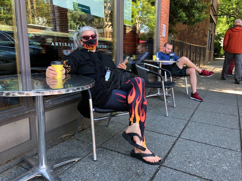 caption: Lauri Miller hasn't had her daily cup of coffee at Cafe Umbria in Ballard for months. She was among a few residents who ventured to cafes and restaurants as they slowly opened back up in June 2020. 
