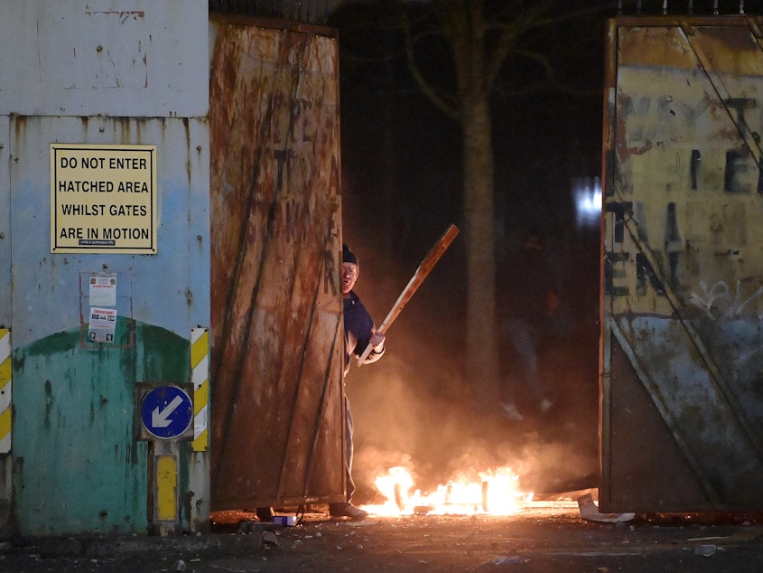 caption: Skirmishes erupt at the "peace wall" dividing Protestant and Catholic neighborhoods in Belfast, Northern Ireland, on Wednesday night.