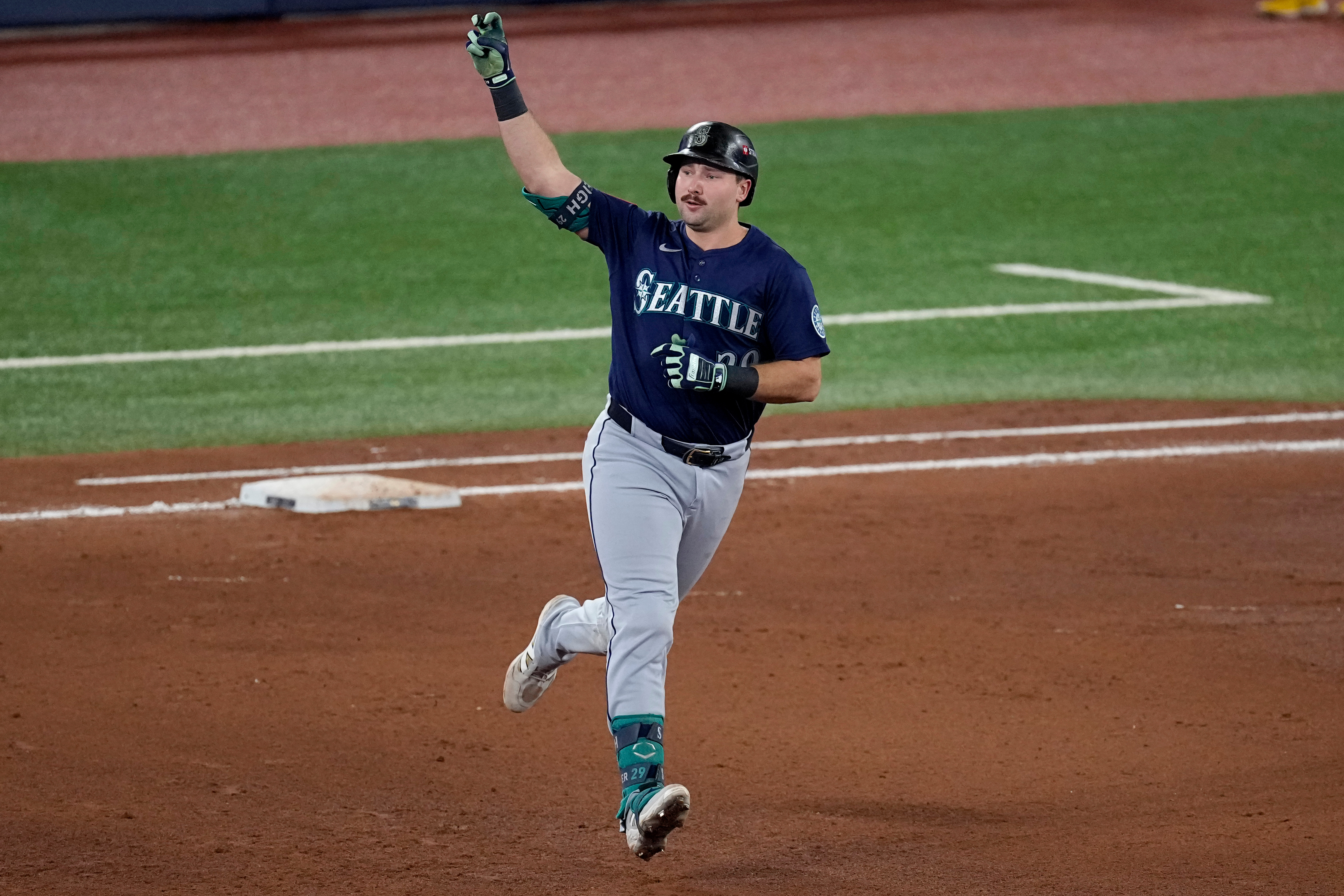 caption: Seattle Mariners' Cal Raleigh celebrates his solo home run off Toronto Blue Jays pitcher Louis Varland during the fifth inning in Game 7 of baseball's American League Championship Series, Monday, Oct. 20, 2025, in Toronto. 