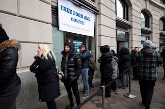 caption: Federal workers stand in line for a free hot meal in Washington, D.C., on Wednesday.