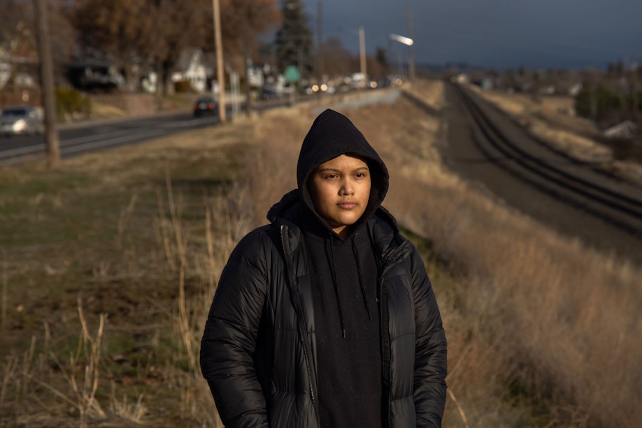 caption: Michelle Aguilar Ramirez walks around her new neighborhood in Spokane, Washington.

