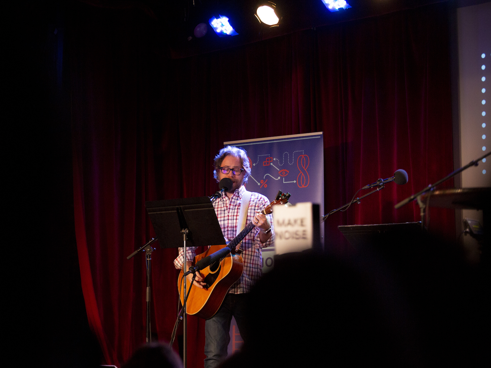 caption: Jonathan Coulton leads a music parody game on <em>Ask Me Another</em> at the Bell House in Brooklyn, New York.