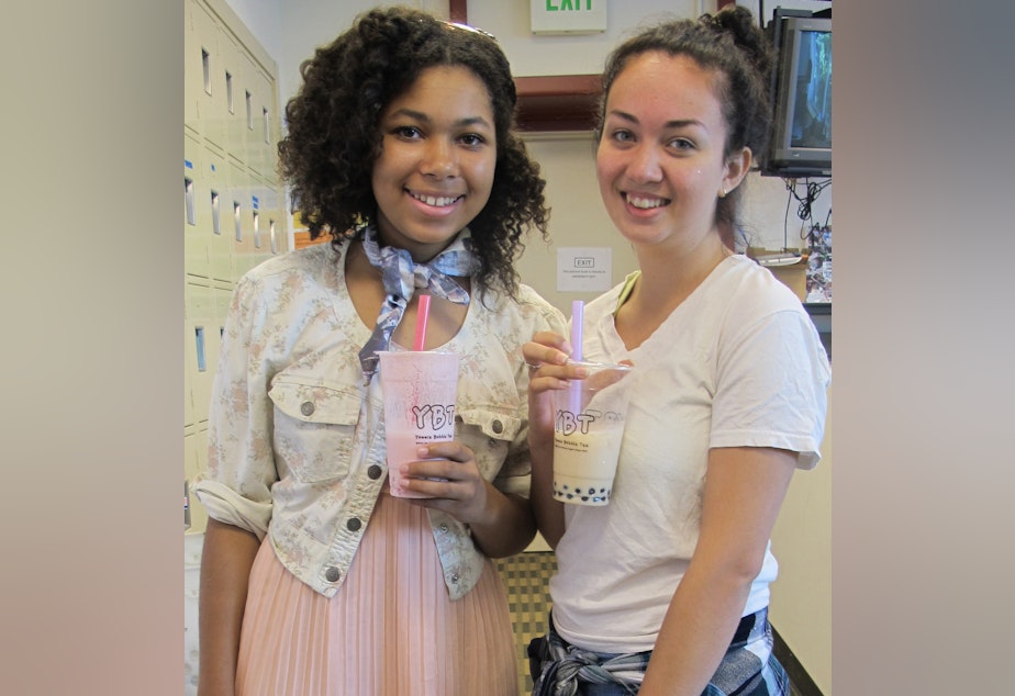 caption: Nia and Noah show off their fashion sense and love of bubble tea.