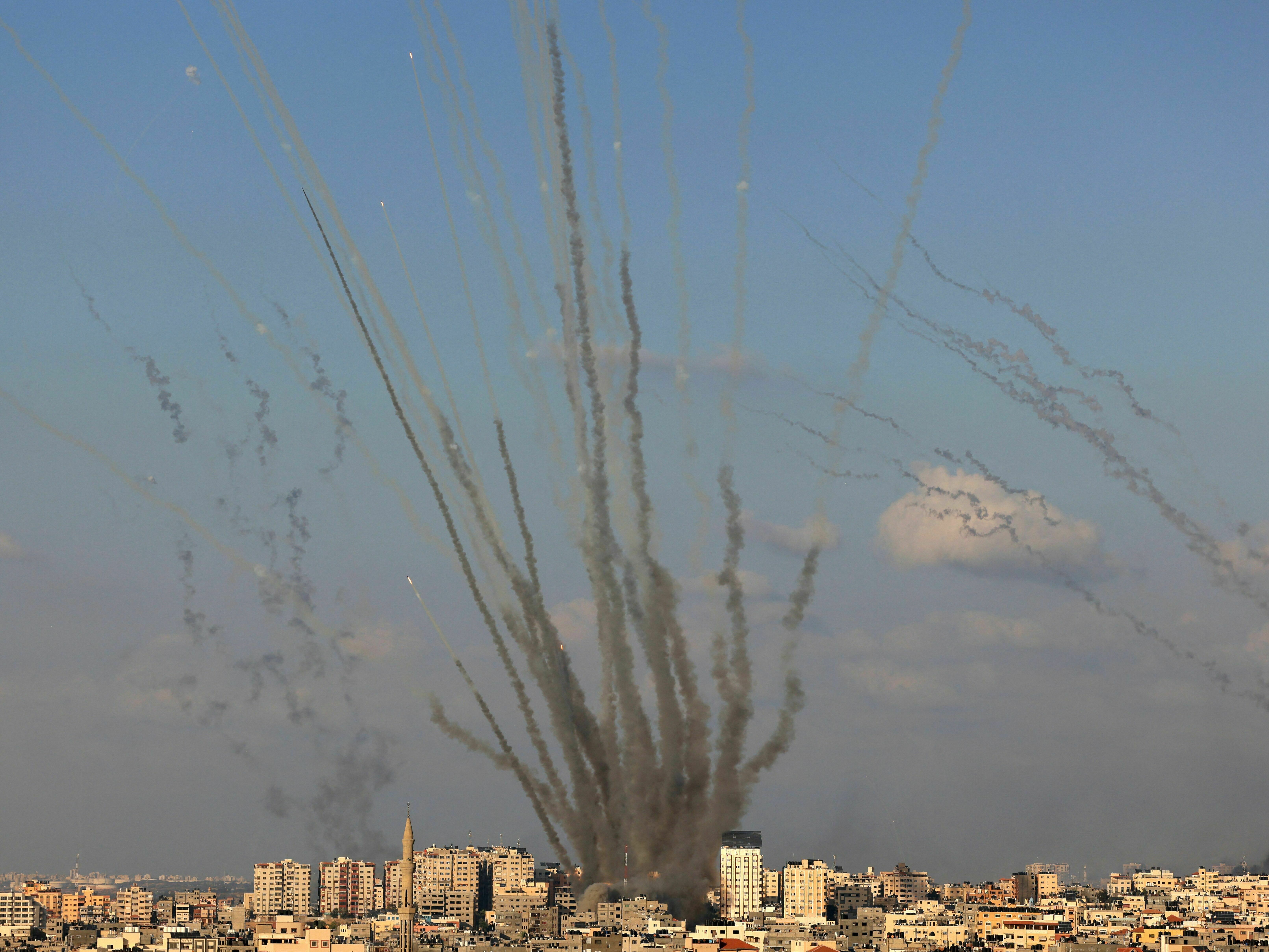 caption: Rockets are fired by Palestinian militants from Gaza toward Israel on Oct. 10.
