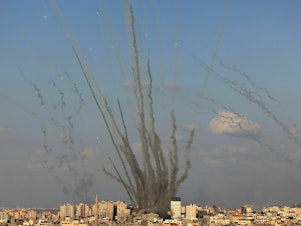 caption: Rockets are fired by Palestinian militants from Gaza toward Israel on Oct. 10.