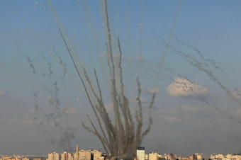 caption: Rockets are fired by Palestinian militants from Gaza toward Israel on Oct. 10.