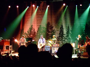 caption: The Decemberists performing as a folk/rock band in 2011.