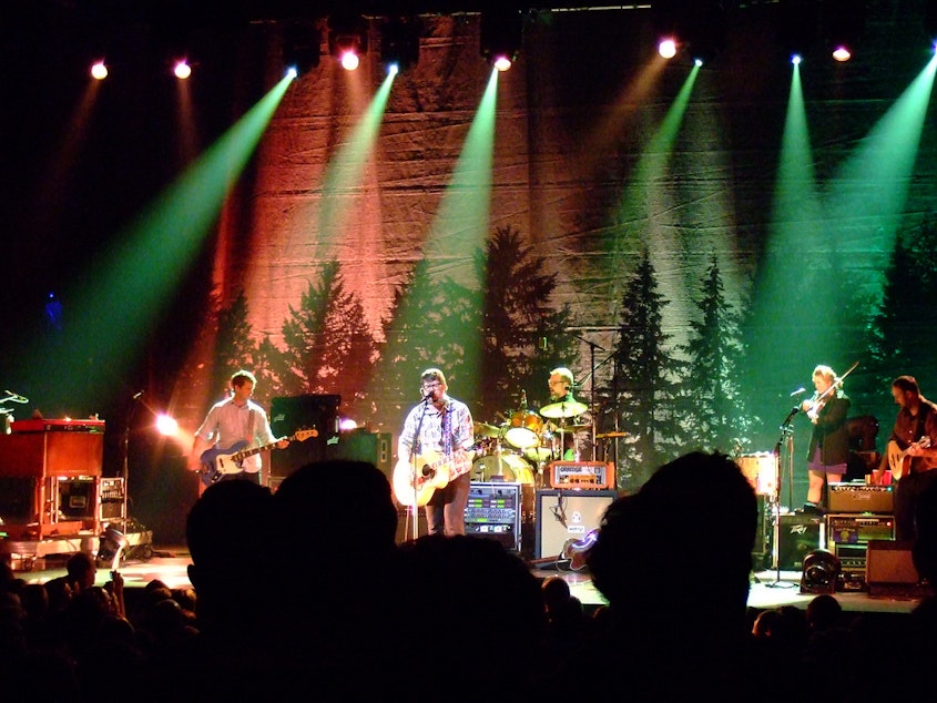 caption: The Decemberists performing as a folk/rock band in 2011.