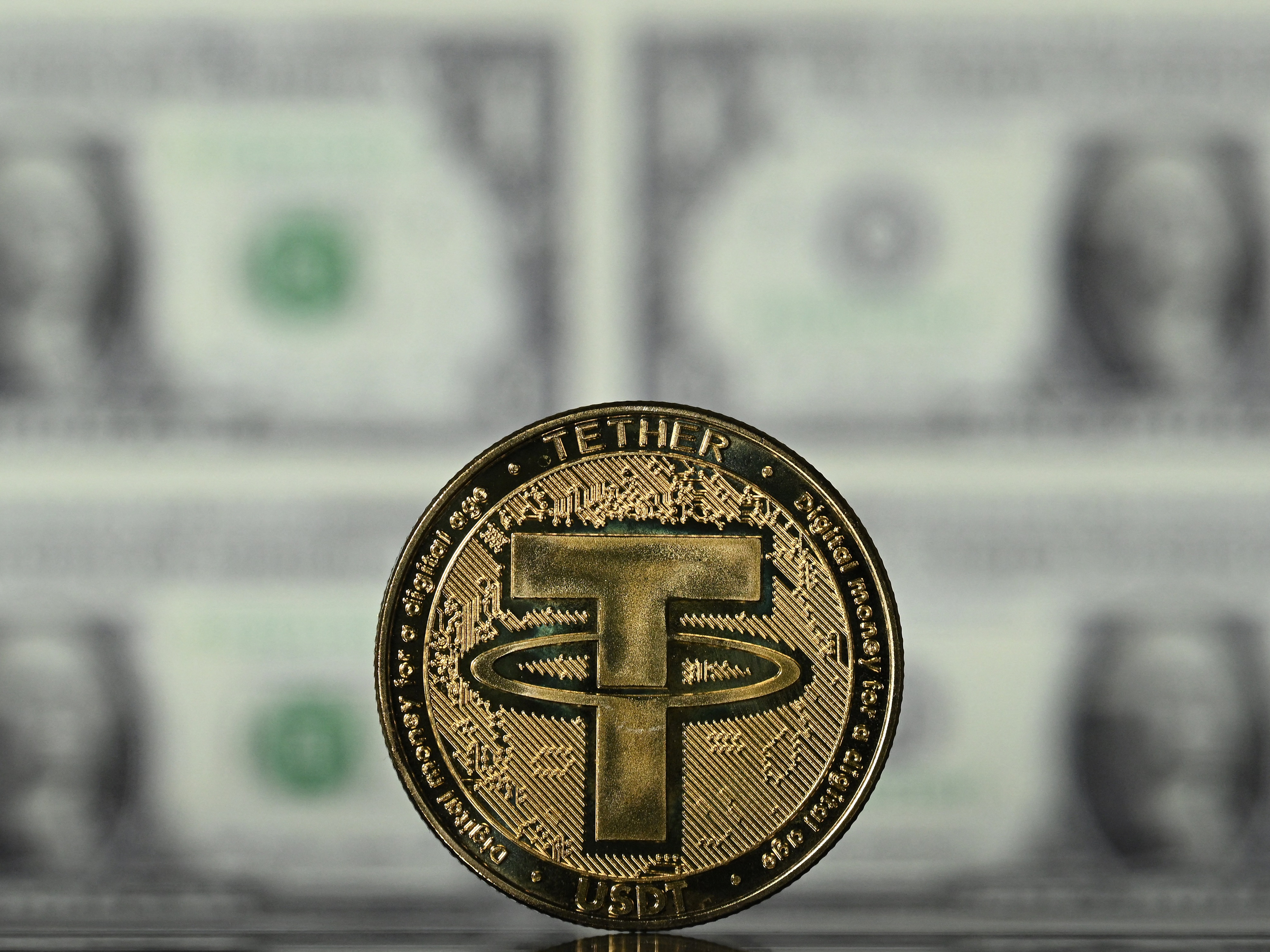 caption: An illustration picture taken in London on May 8, 2022, shows a souvenir Tether (USDT) coin, which is one of the world's biggest stablecoins.