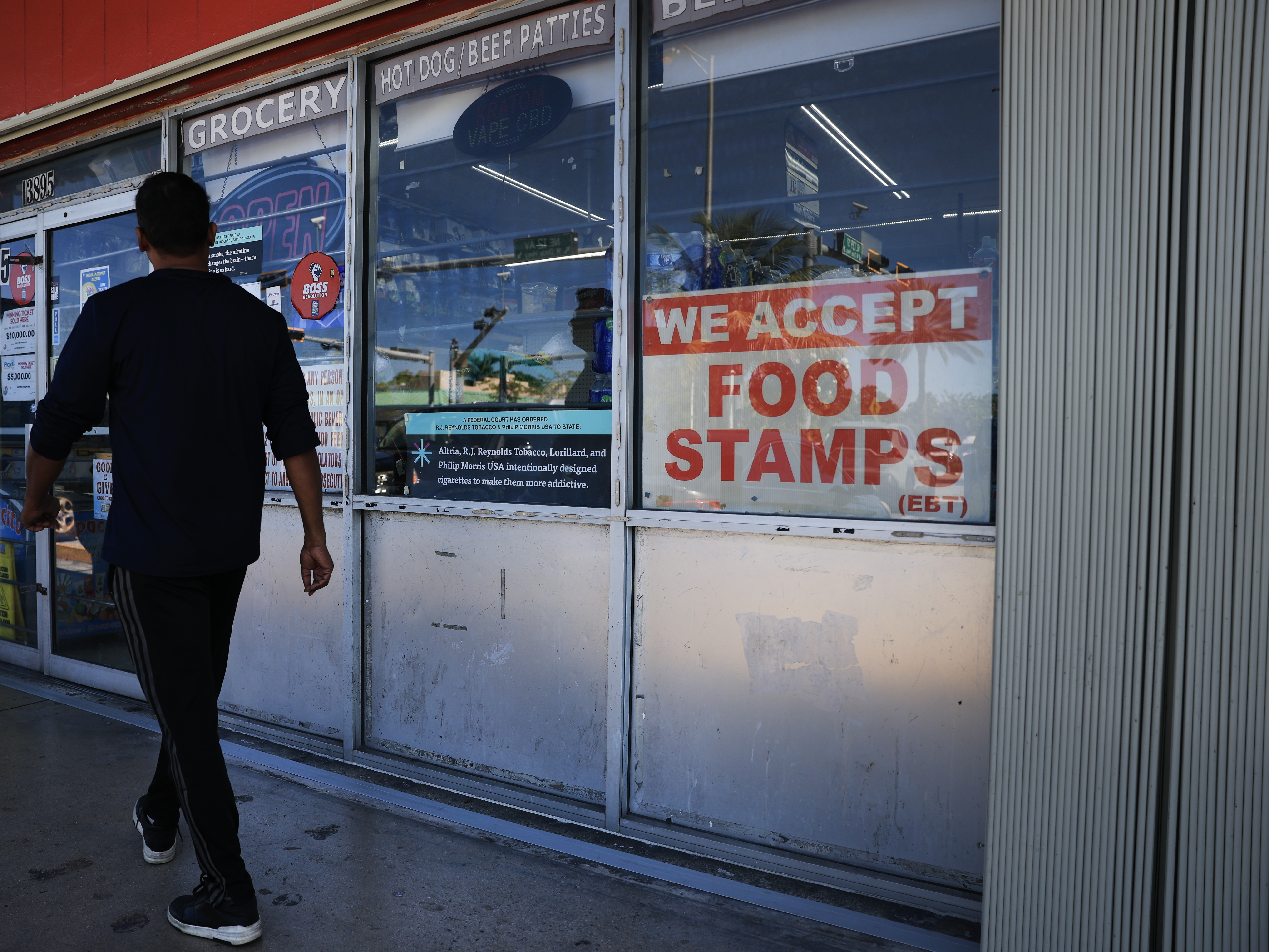 caption: A 'We Accept Food Stamps' sign hangs in the window of a grocery store on Oct. 31 in Miami. The Trump administration is targeting the food stamp program, now known as the Supplemental Nutrition Assistance Program (SNAP), for major changes, citing data about the program it has demanded from the states that administer the program.