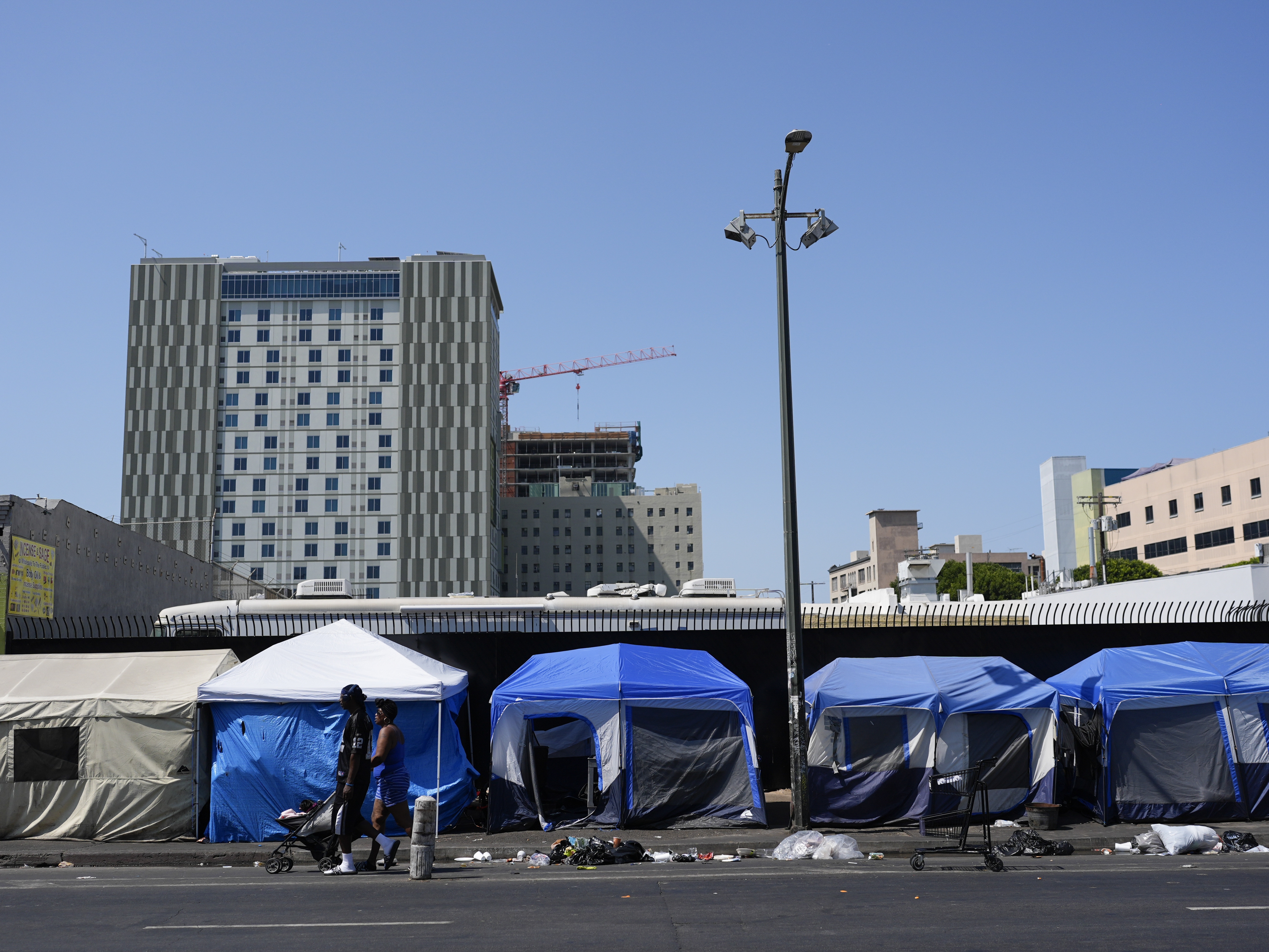 caption: Tents are lined up on Skid Row Thursday, July 25, 2024, in Los Angeles.