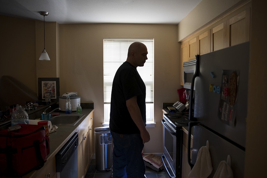 caption: Kevin Boggs stands in his kitchen while microwaving spaghettios on Friday, December 7, 2018, at his apartment in Seattle. 