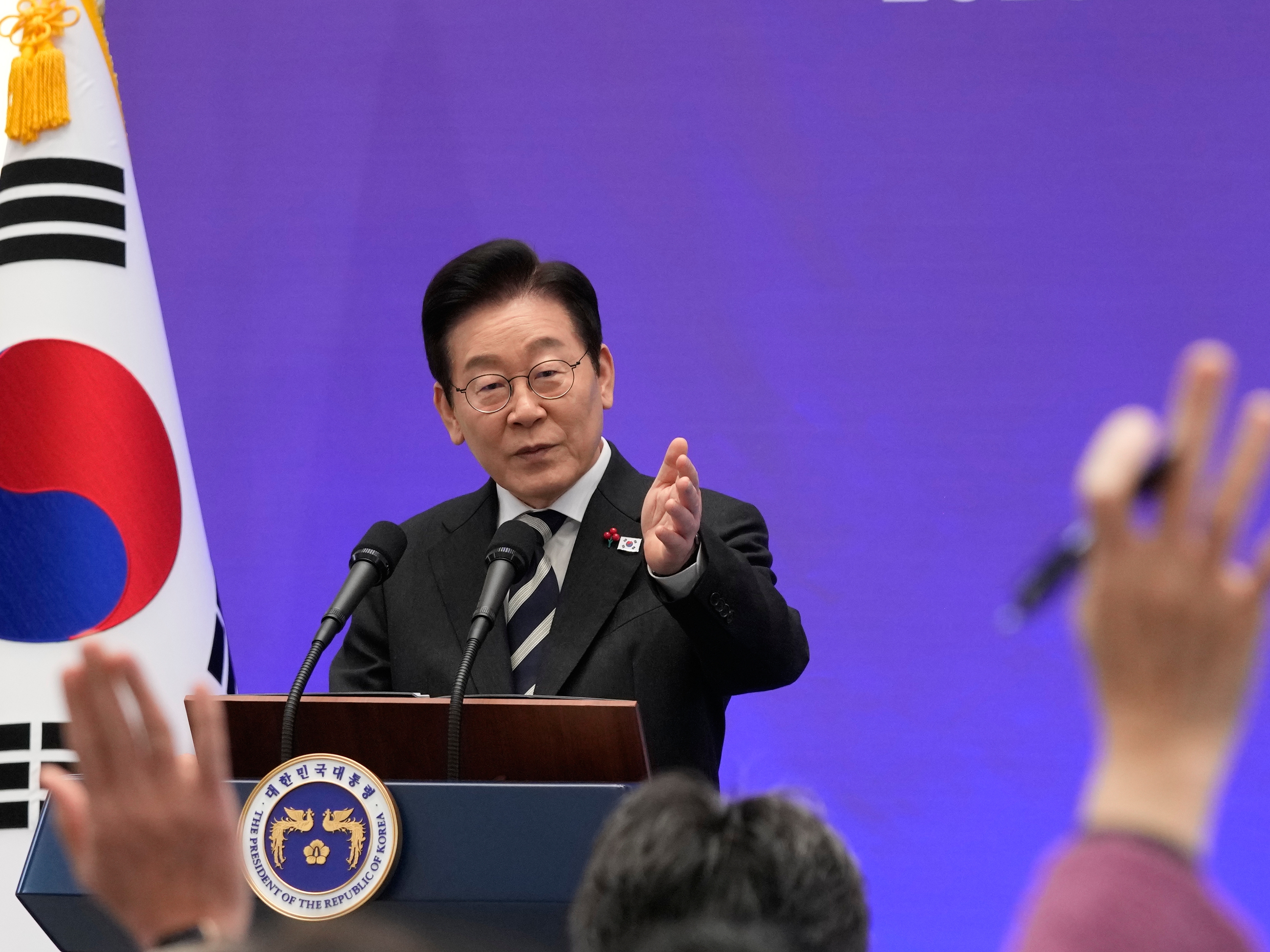 caption: South Korean President Lee Jae Myung gestures during a news conference to mark the first  anniversary of the Dec. 3 martial law crisis at the Blue House in Seoul, South Korea on Wednesday.