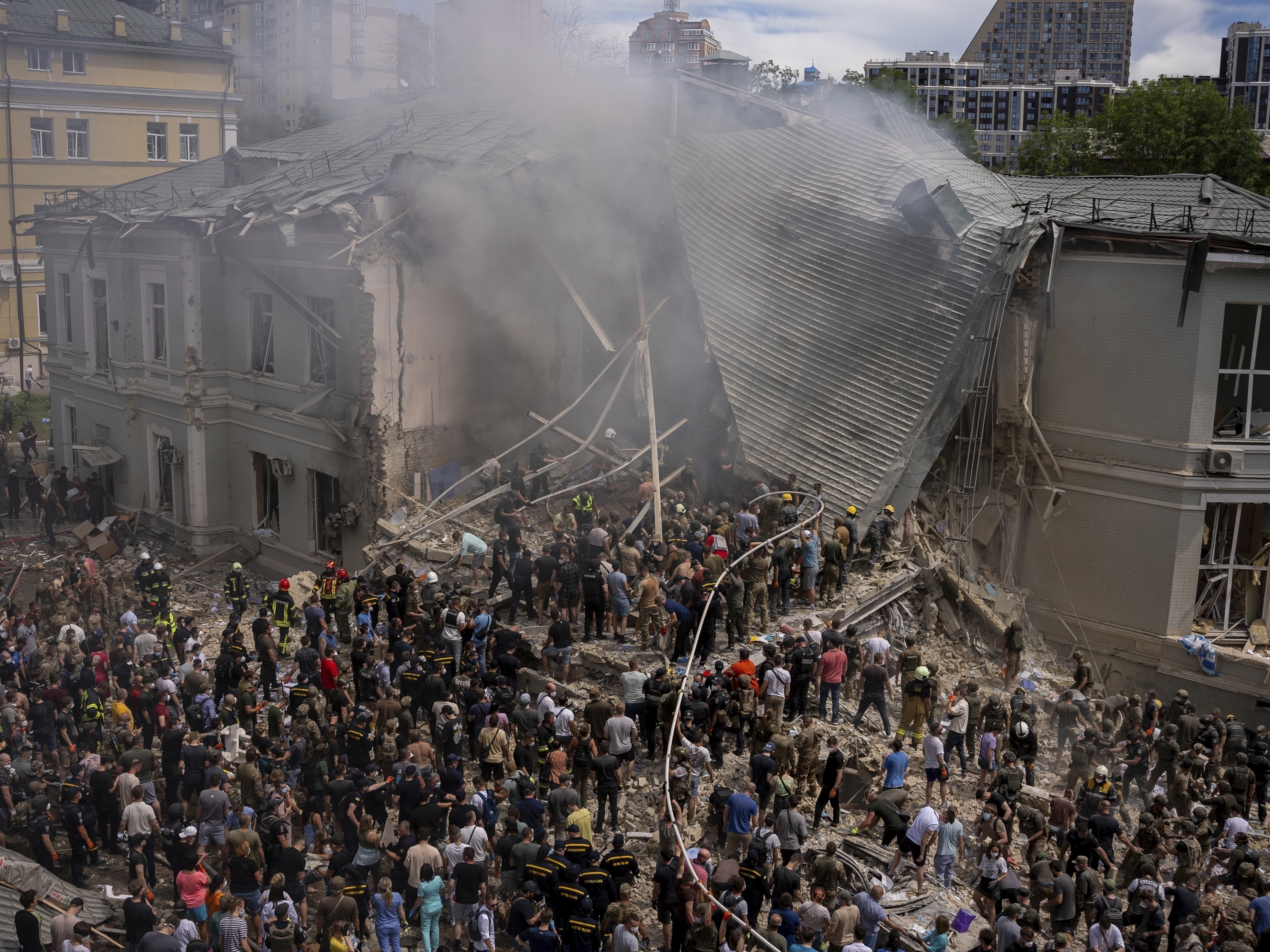 caption: Ukrainian emergency workers respond at the Okhmatdyt Children's Hospital in the capital Kyiv after it was hit by a Russian missile on July 8.