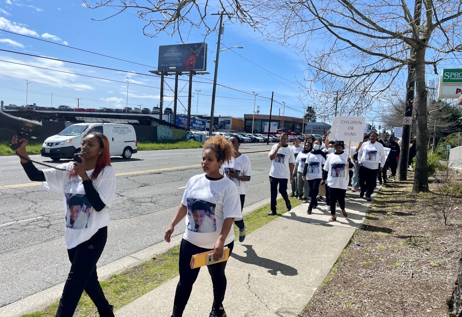 caption: Elrohi Shuge leads chants as a group of over 50 students and family members of Ebenezer Haile marched to Ingraham High School to fight against gun violence. 