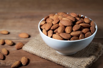 caption: Thanks to a genetic mutation thousands of years ago, modern domesticated sweet almonds are delicious and safe to eat.