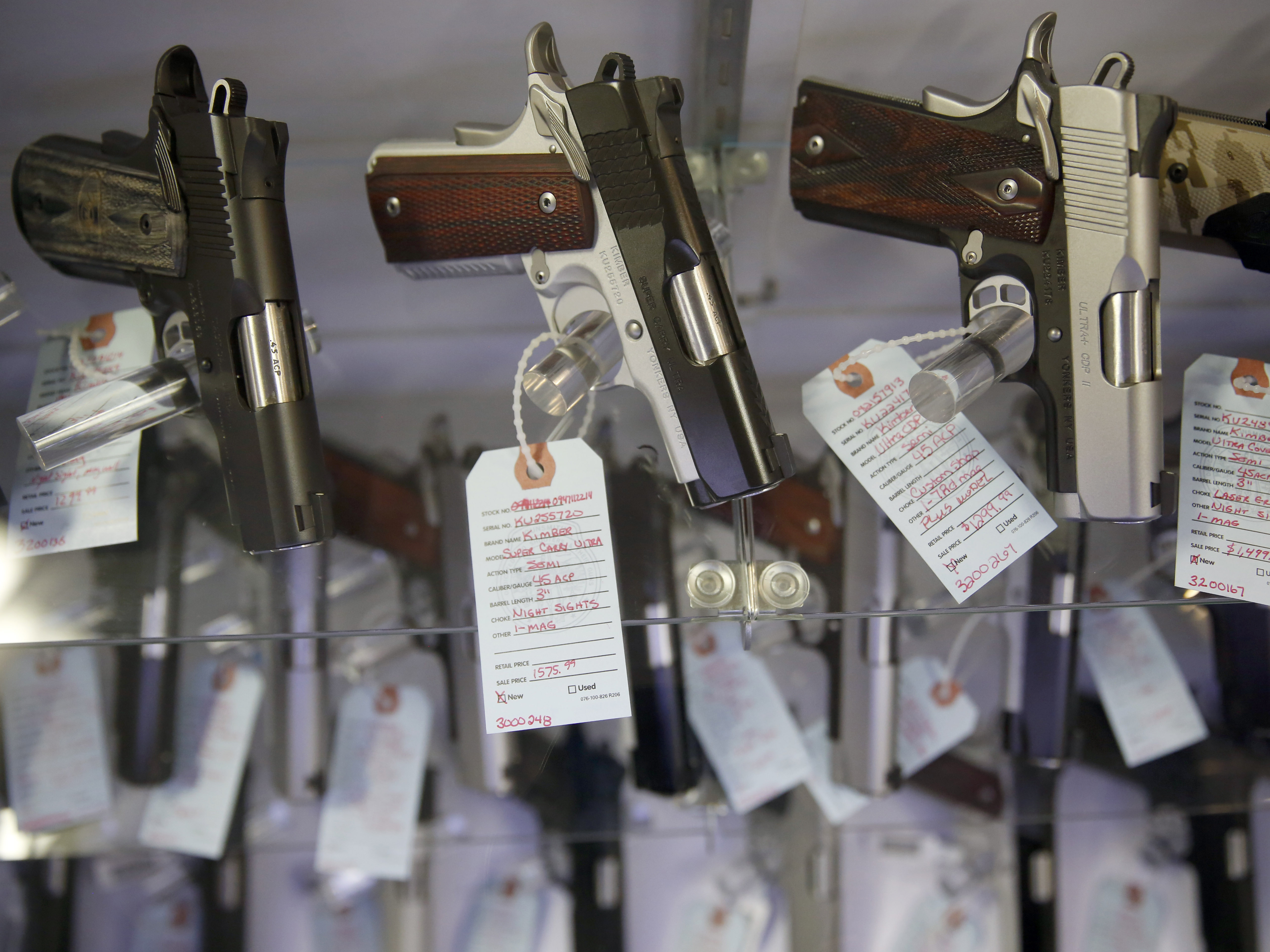 caption: Handguns sit in a glass display case in Bridgeton, Mo.