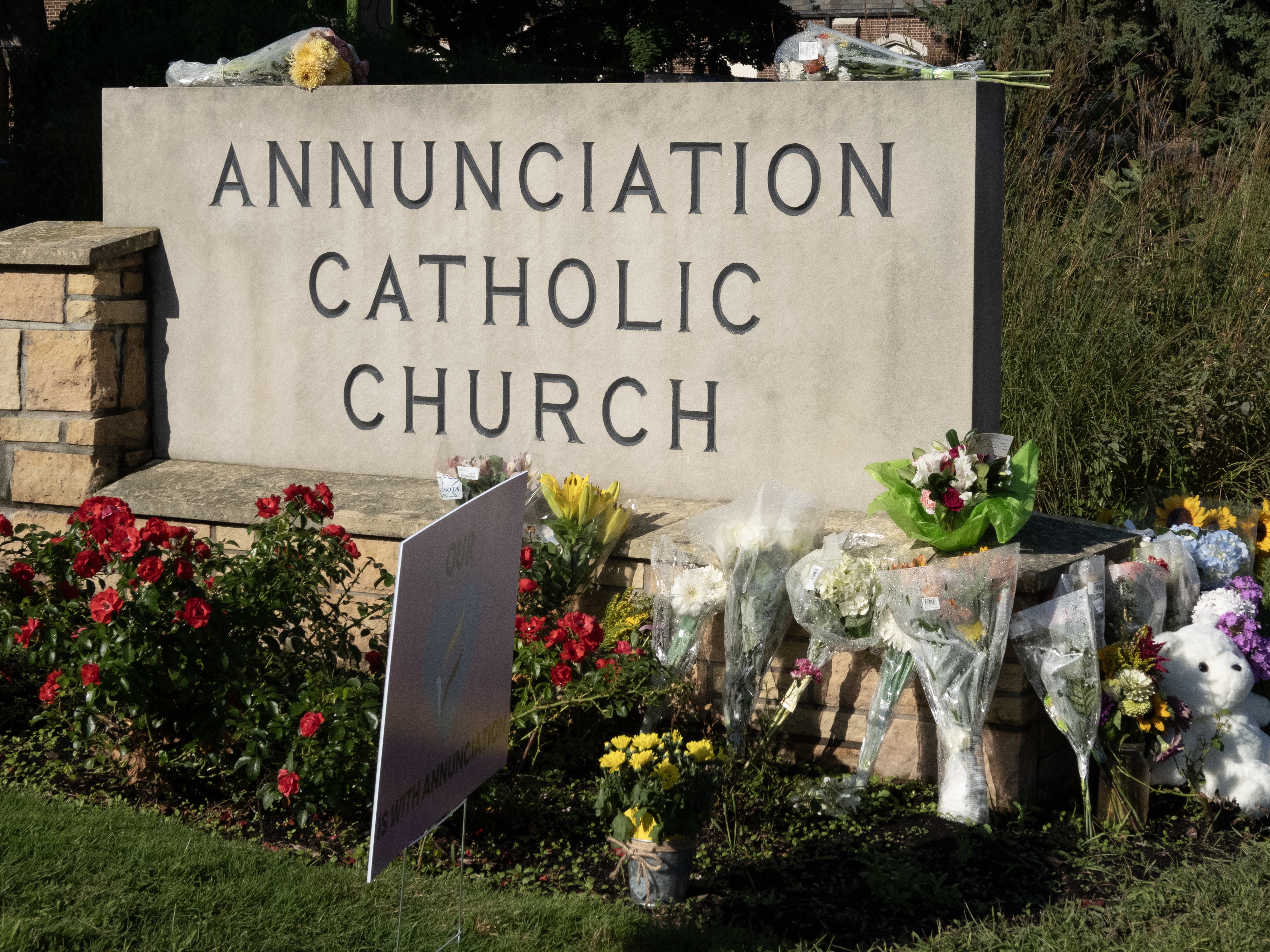 caption: A memorial to shooting victims sits in front of Annunciation Catholic Church in Minneapolis on Aug. 28. A shooter fired through the windows of the church while students were sitting in pews during a Catholic school Mass. The assailant died at the scene from a self-inflicted gunshot wound, according to police.