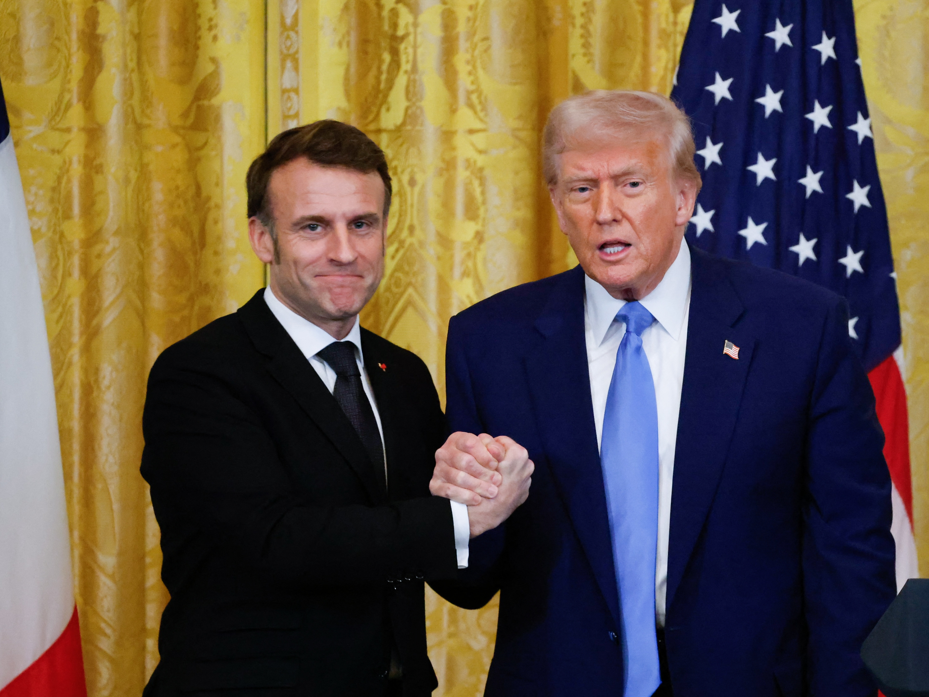 caption: President Trump and French President Emmanuel Macron shake hands at the end of a joint press conference in the East Room of the White House on Monday.