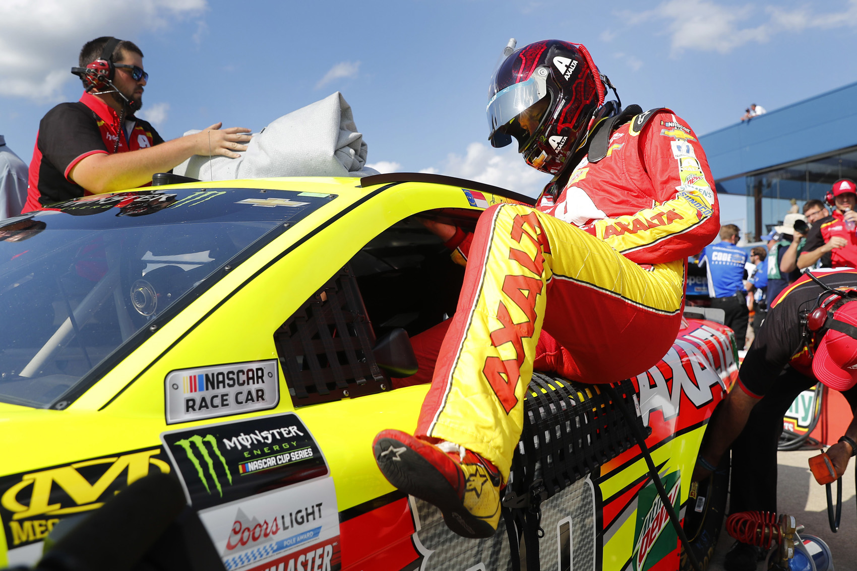 caption: Dale Earnhardt Jr. enters his car for qualifying for the NASCAR Cup Series auto race in Brooklyn, Mich., Friday, Aug. 11, 2017. (AP Photo/Paul Sancya)