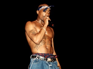 caption: The investigation into the murder of Tupac Shakur (on stage here in 1994) has long evaded closure. But in the last month, an arrest in connection with his shooting on Sept. 7, 1996, has brought the case back into the spotlight.