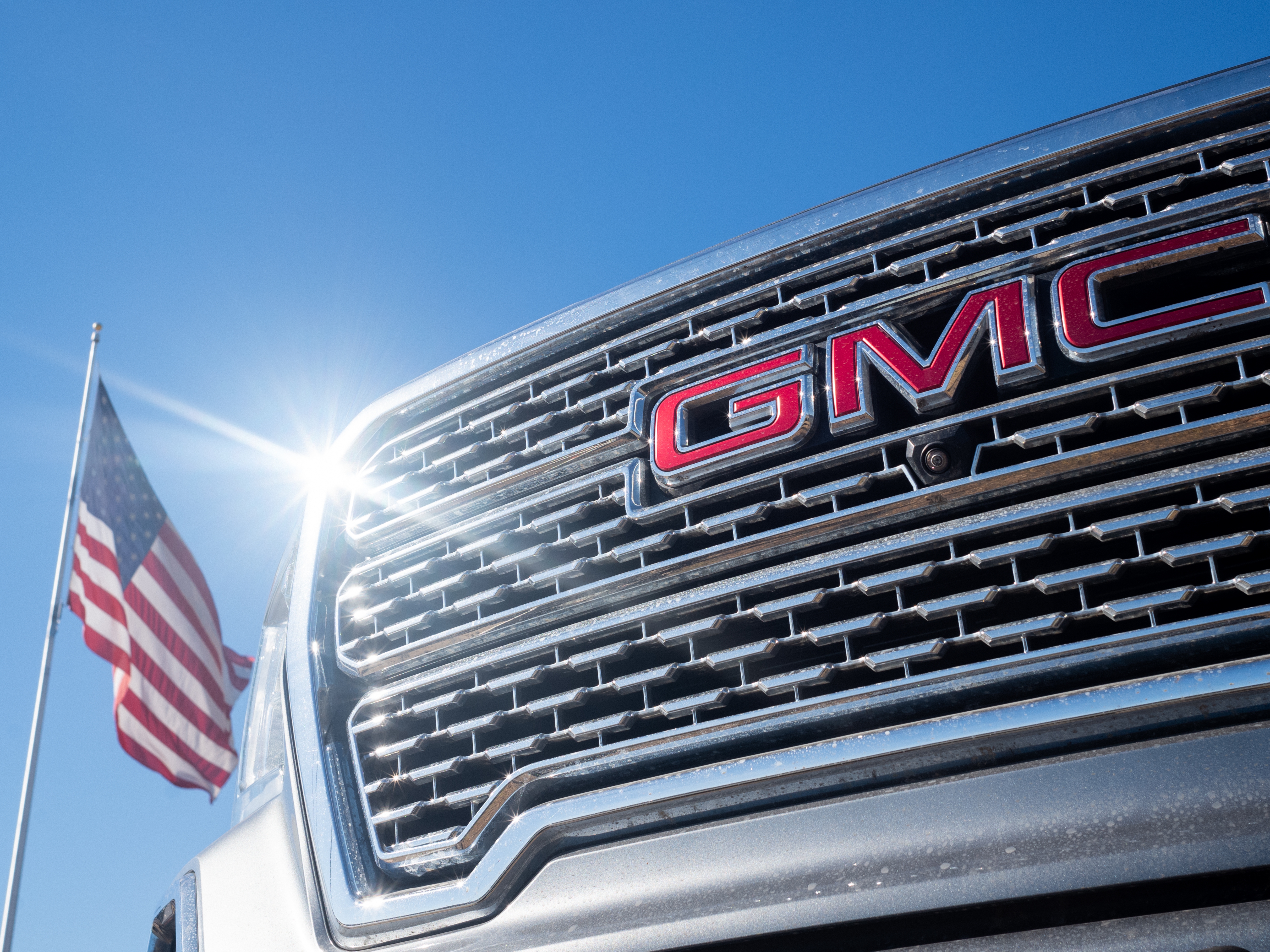 caption: AUSTIN, TEXAS: A GMC pickup truck is displayed for sale on a lot at a General Motors dealership in Austin, Texas. Last year, General Motors told investors in its annual report that "we are committed to fostering a culture of diversity, equity and inclusion." But in its latest report, published last week, GM doesn't mention diversity once. (Photo by Brandon Bell/Getty Images)