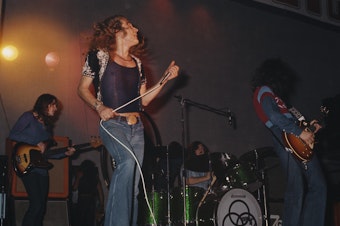 caption: Led Zeppelin performing at the Empire Pool in London.