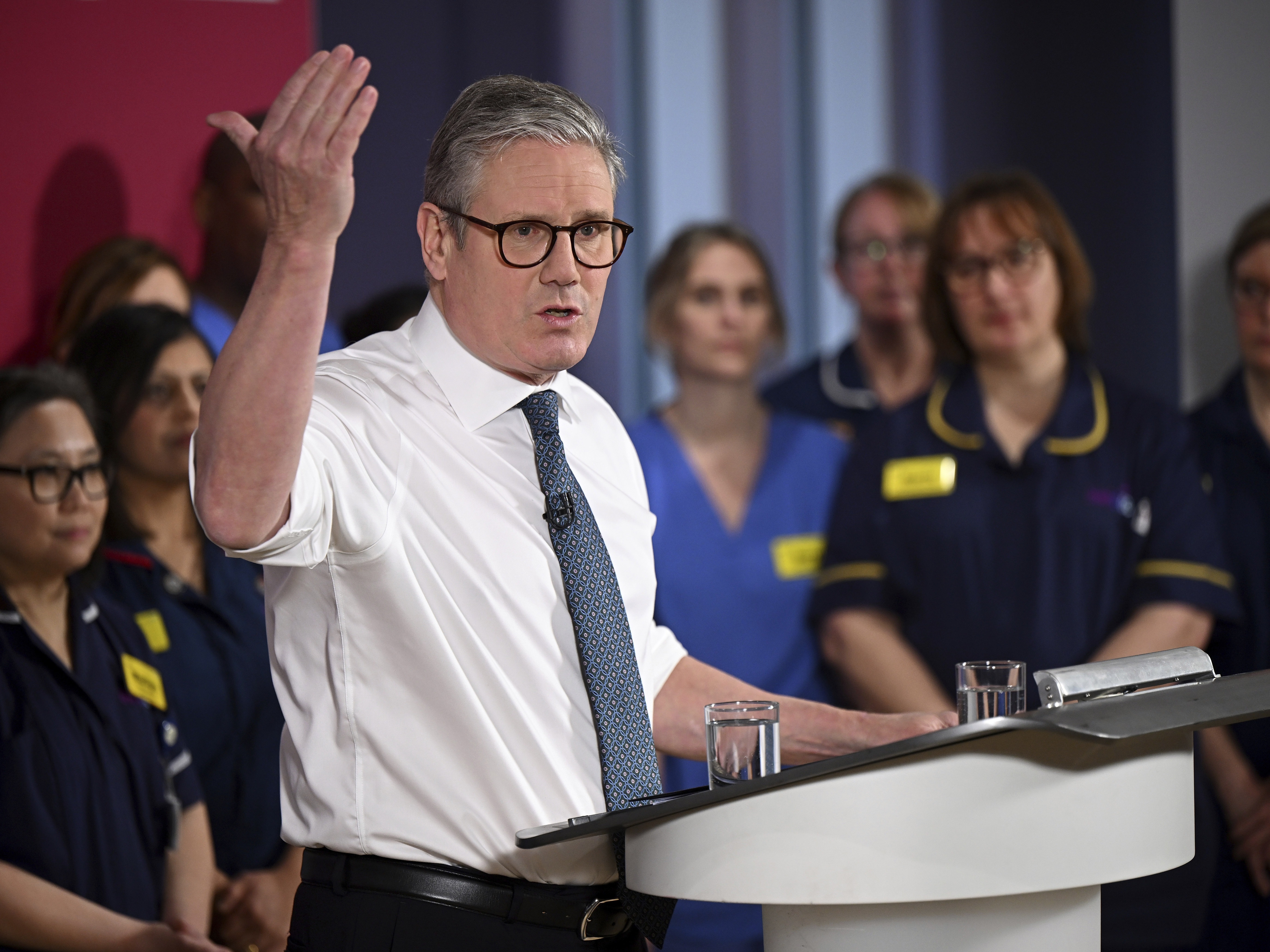 caption: Britain's Prime Minister Keir Starmer gives a speech on reducing NHS wait times as he visits a health care provider in Surrey, England, Monday, Jan. 6, 2025.