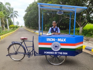 caption: Vinisha Umashankar and her solar ironing cart. She came up with the idea when she was 12 — then worked with engineers to create a prototype. Now she's in Glasgow, Scotland, to speak at the COP26 climate change conference.