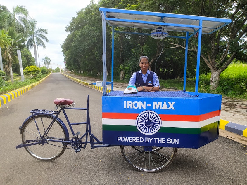caption: Vinisha Umashankar and her solar ironing cart. She came up with the idea when she was 12 — then worked with engineers to create a prototype. Now she's in Glasgow, Scotland, to speak at the COP26 climate change conference.