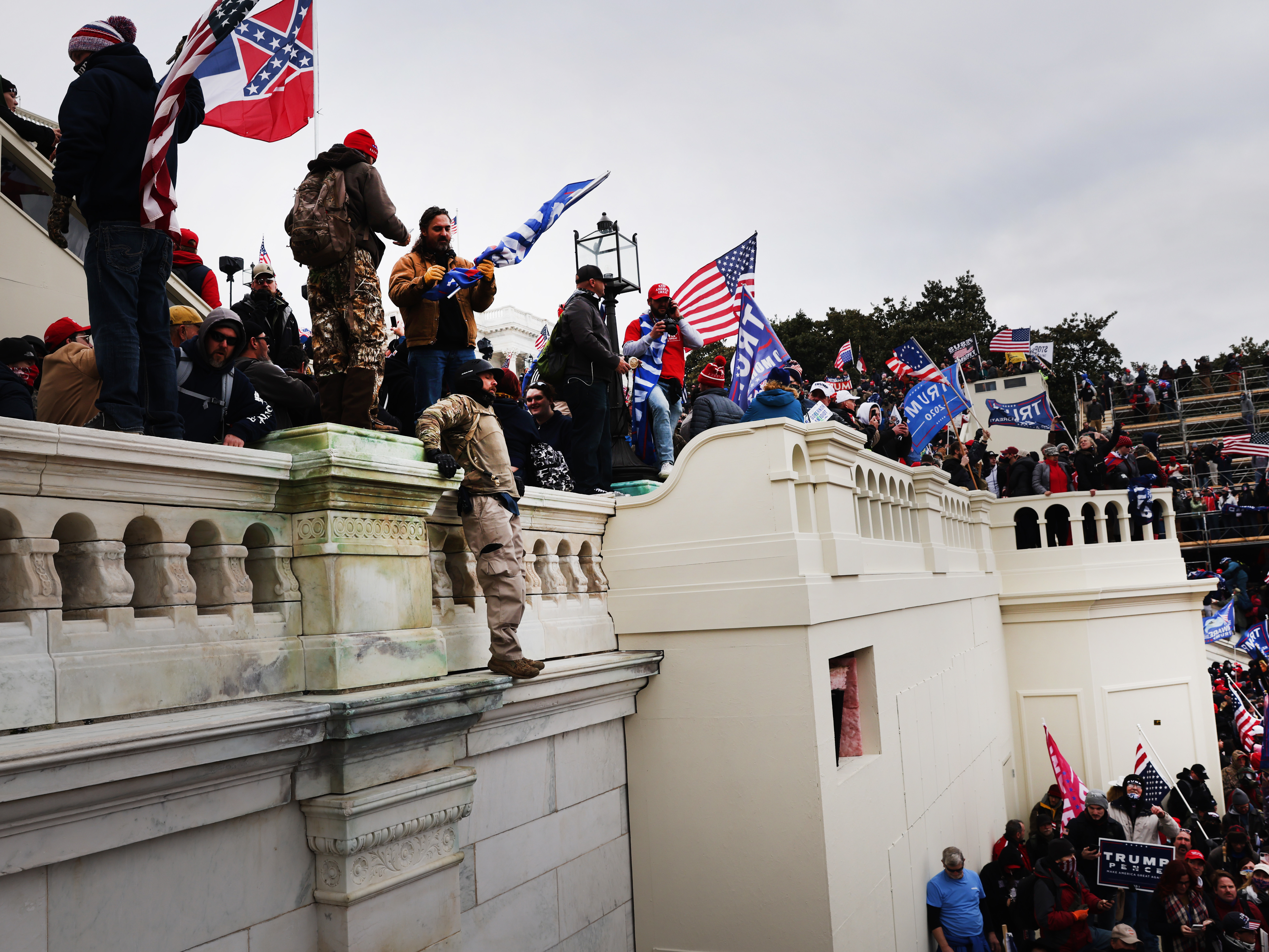 caption: Thousands of supporters of former President Donald Trump storm the U.S. Capitol following a "Stop the Steal" rally on Jan. 6. Prosecutors are working on hundreds of charges related to the breach.