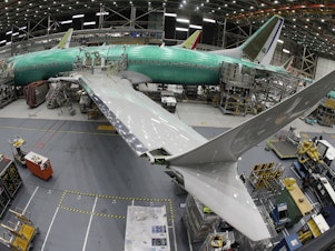 caption: A Boeing 737 MAX 8 airplane sits on the assembly line at Boeing's 737 assembly facility in 2019.