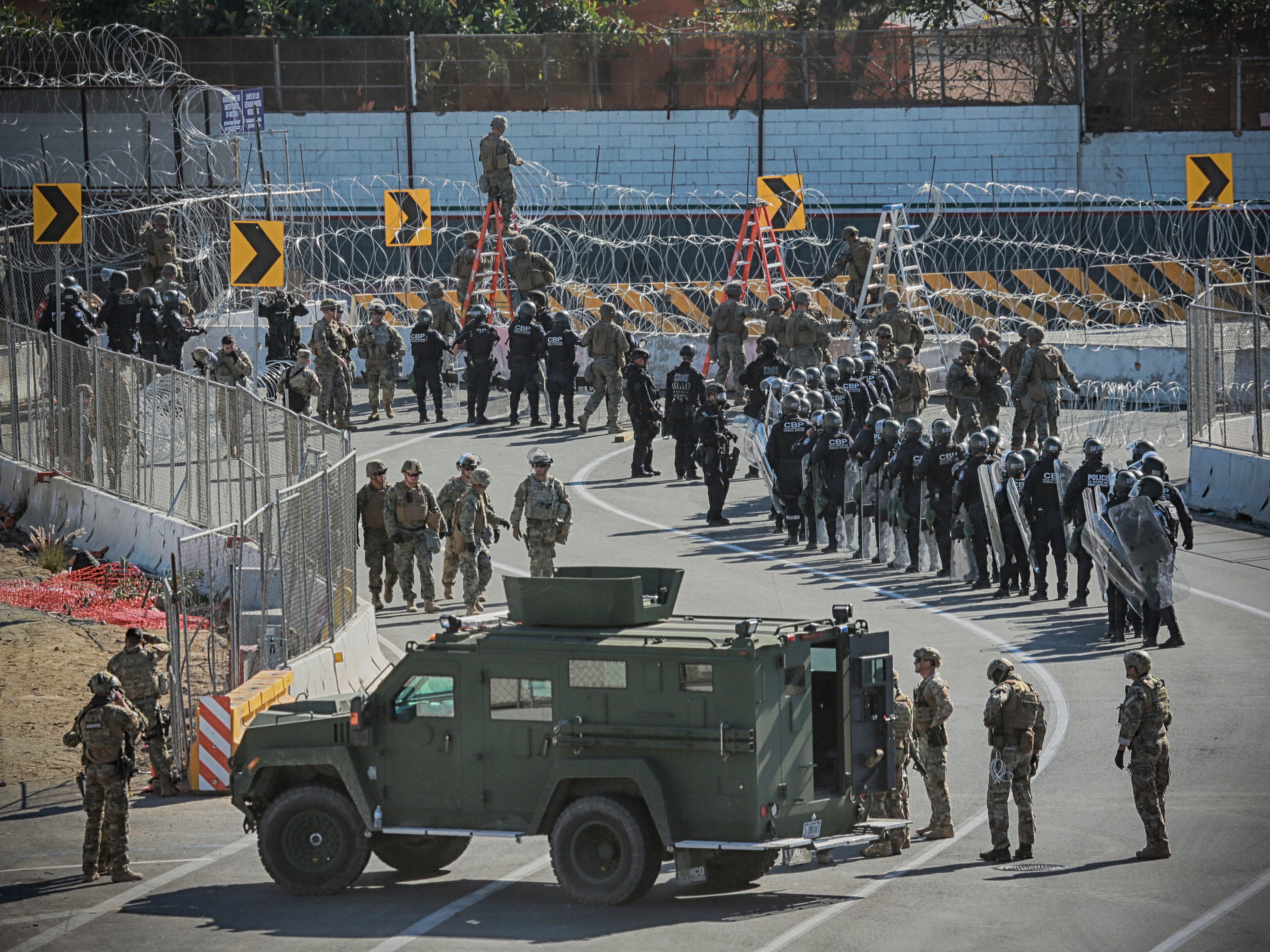 caption: U.S. military and border agents secure the United States-Mexico border at the San Ysidro border crossing south of San Diego, Calif. on Nov. 25.