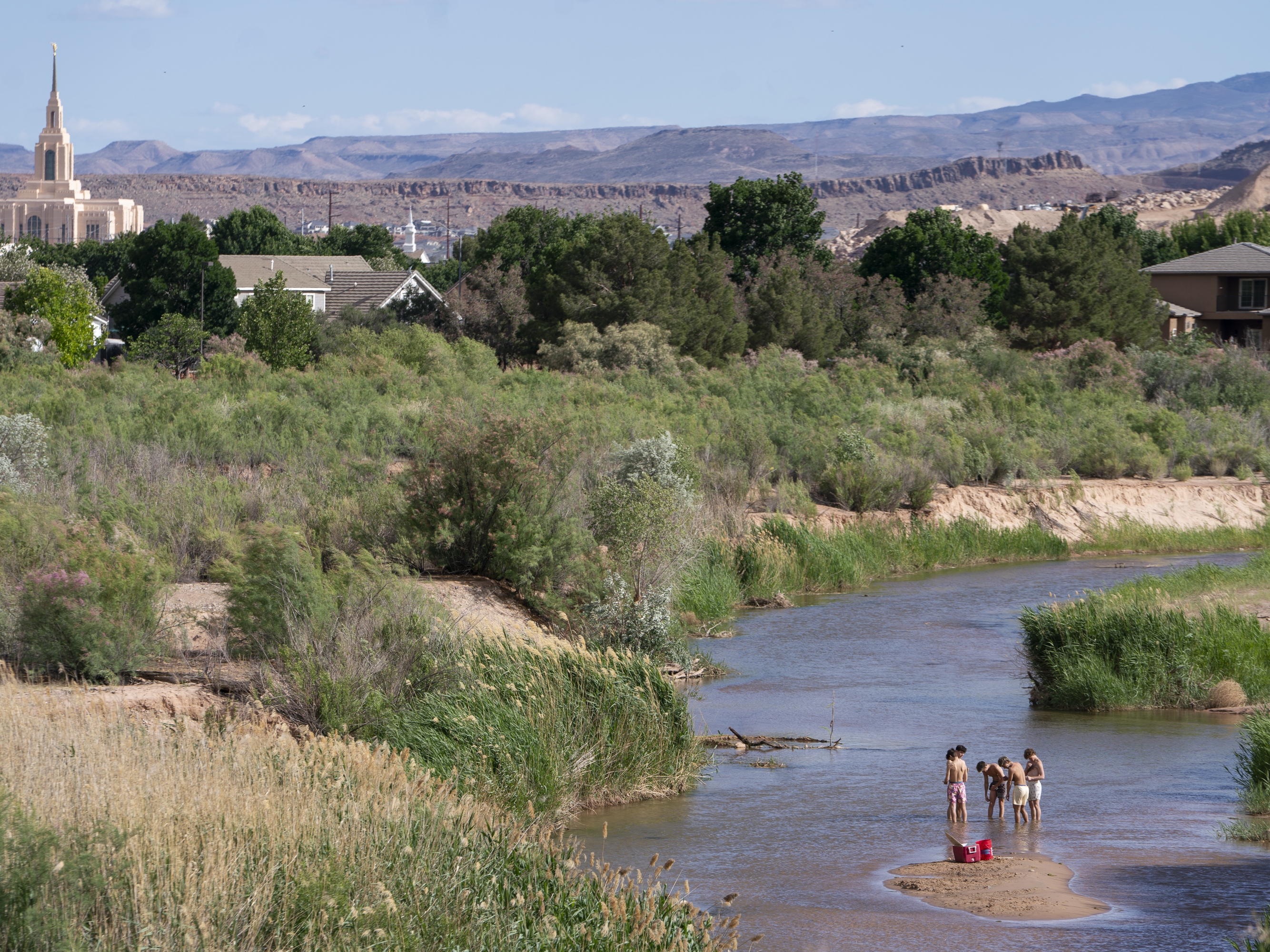 caption: People wade in the shallow waters of the Virgin River in St. George, Utah. The river provides the desert community with water, but climate change and a growing population threaten that supply. Local leaders are looking toward recycled sewage as a solution.