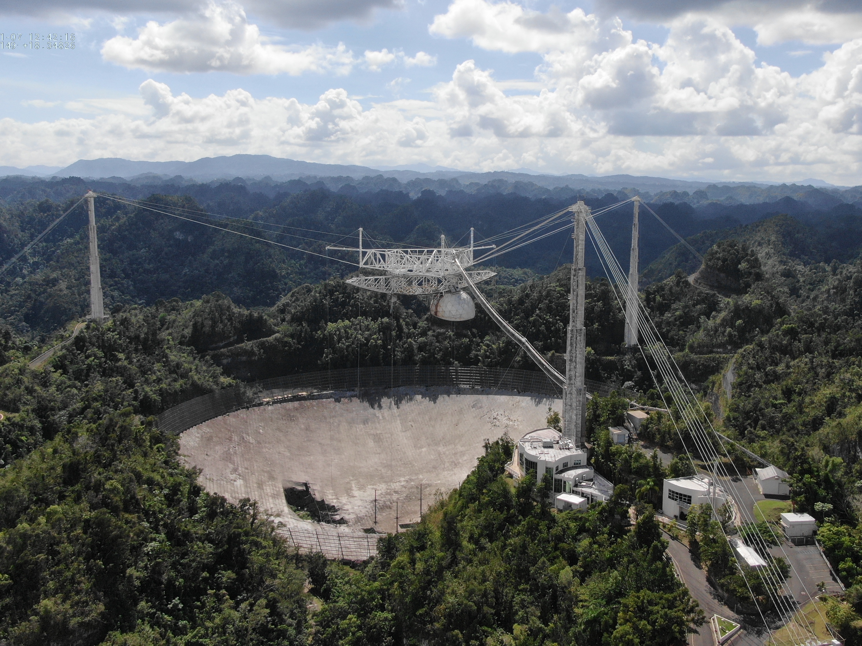 caption: The Arecibo Observatory's mammoth telescope collapsed overnight. It's seen here in November, after a cable damaged its dish.