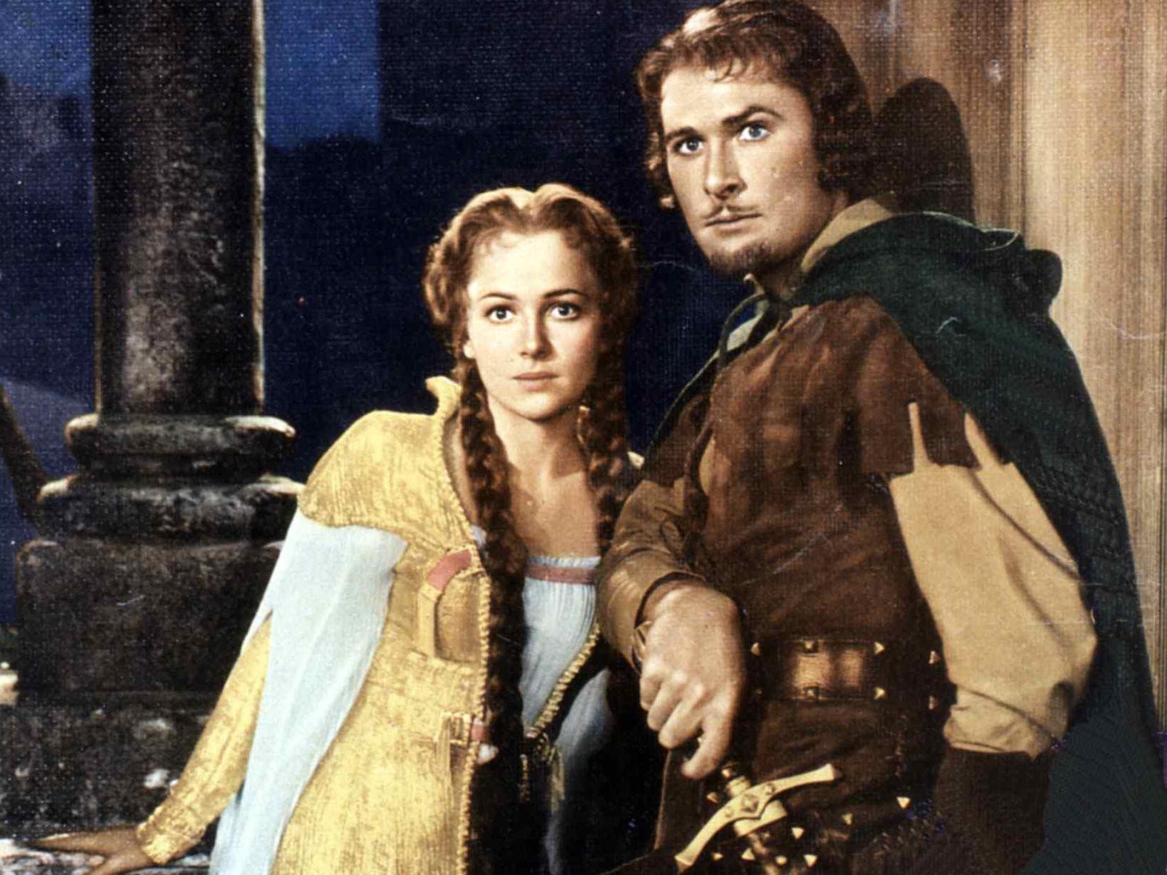 caption: A Robin Hood society in the U.K. is welcoming new followers online, even if some of them found the group while looking for the Robinhood stock app. Here, Errol Flynn portrays Robin Hood alongside Olivia de Havilland as Maid Marian in a film about the famously generous bandit.
