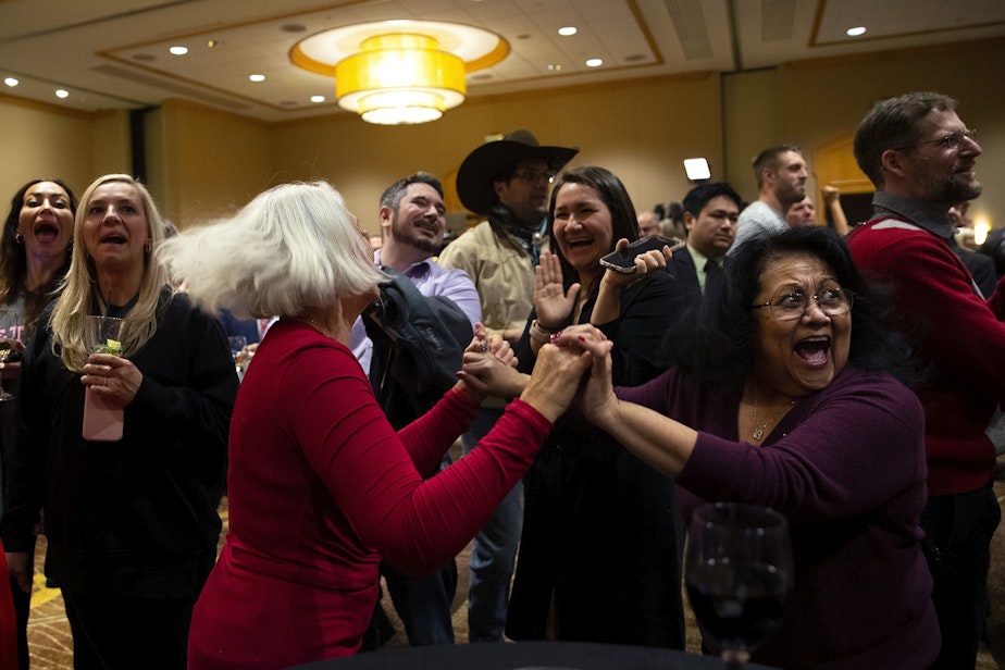caption: Debbie Blodgett, left, and Mary Jennings, right, celebrate as election results appear on screen during a Republican Party election night gathering on Tuesday, November 8, 2022, at the Hyatt in Bellevue. 